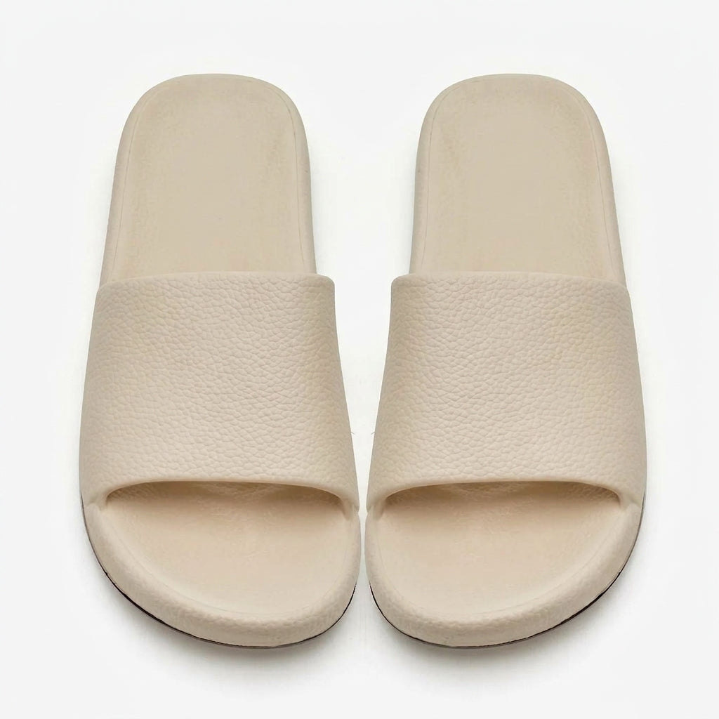 Women's cream textured comfort slides on white background