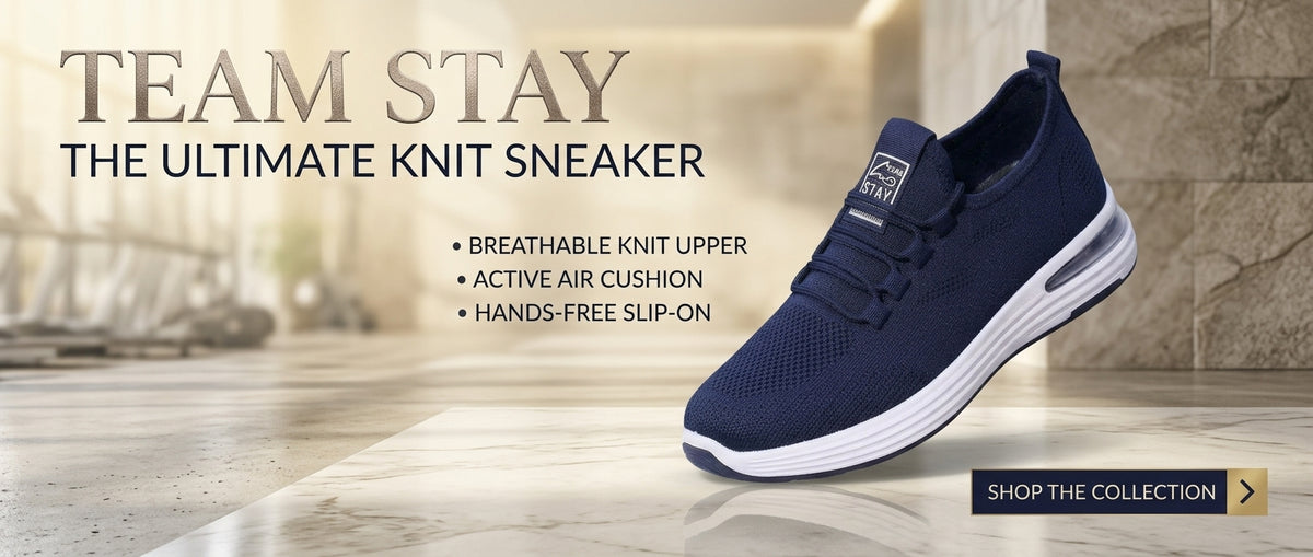 UHR Collection Premier Runner men's navy blue mesh running shoe displayed on a luxury dark navy and champagne marble platform with satin drapes and branding text